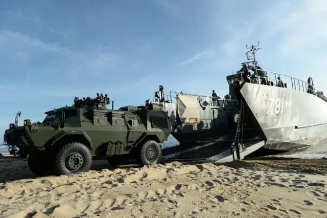 Thai Marines unload army vehicles from a sea vessel as units change shifts to patrol the coast in the southern Thai province of Narathiwat, near the Malaysian border, on September 29, 2017. The rangers change shifts for routine patrols along the coast as part of the military's counter-insurgency operation in the "Deep South" border provinces. / AFP PHOTO / Madaree TOHLALA (Photo credit should read MADAREE TOHLALA/AFP via Getty Images)