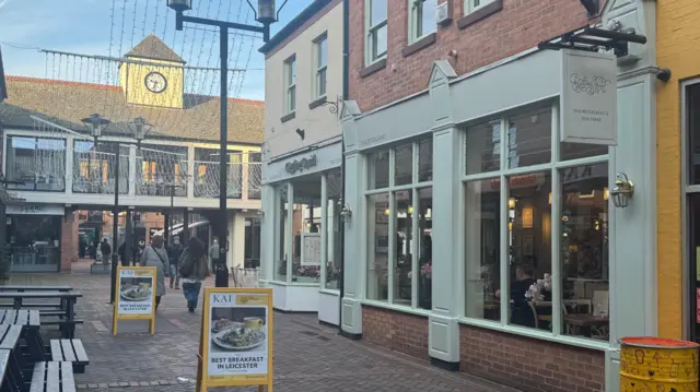 El exterior de un restaurante en una plaza peatonal.