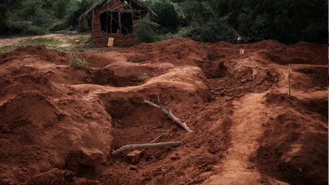 Open shallow graves after bodies were exhumed