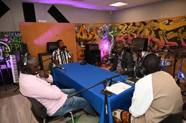 Felin Gakwaya mu kiganiro na Santos Bigabo, icyegera cy'umurwi wa Mulenge FC, umutoza wayo Nzovu Sebagabo, hamwe na capitaine wayo Fabrice Rugenerwa.