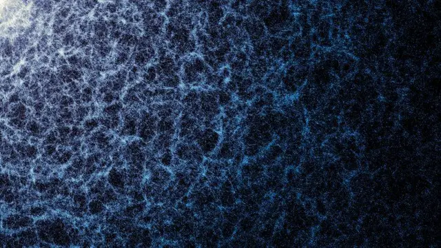 Una imagen de fondo negro con una textura de filamentos y puntos azules y blancos, con unas zonas más densas y de color más intenso que otras.
