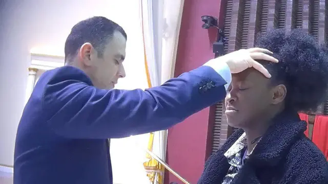 Pastor lay hand on BBC reporter head