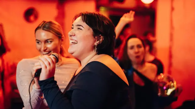 ሁለት ሴቶች እየዘፈኑ