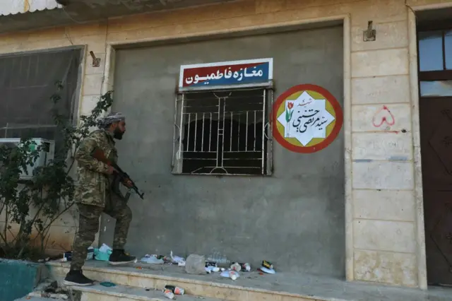An anti-government fighter inspects a base belonging to the Iran-backed Fatemiyoun brigade in the town of Khan Sheikhun in Syria.
