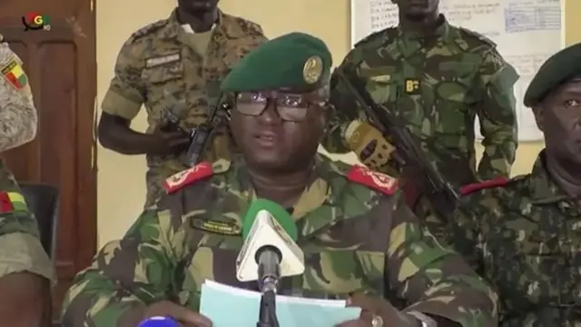 The head of the presidential military office in Guinea-Bissau, Denis N'Canha (center), announcing with a group of officers that total control of the country had been taken at the headquarters of the general staff in Bissau, Guinea-Bissau, on November 26, 2025.