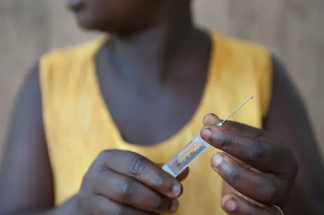 Woman holding syringe
