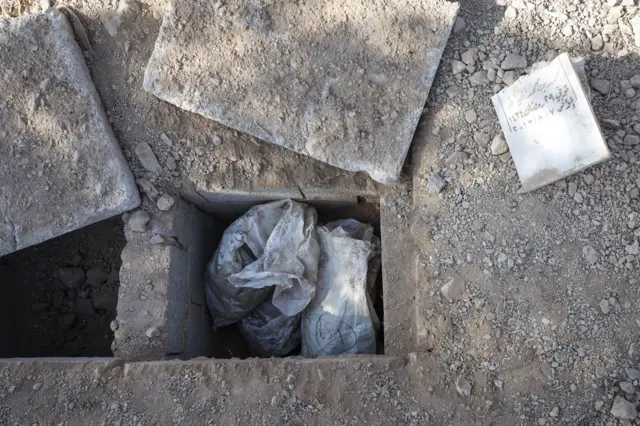 Bags containing human remains in a mass grave near the Syrian capital, Damascus, on December 18, 2024.