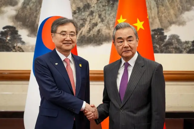 조현 외교부 장관이 왕이 중국 외교부장과 악수하고 있다