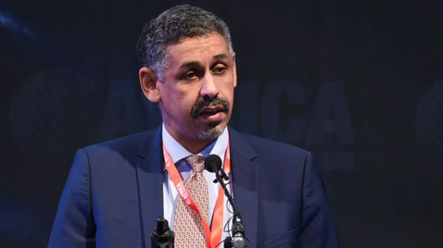 Sidi Ould in front a mic wit im stripe tie