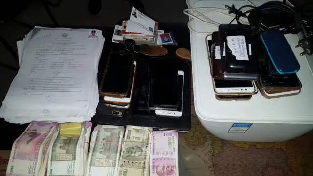 जून 2018 में नक़ल करने के आरोप में मेरठ से गिरफ़्तार 22 लोगों के पास से बरामद मोबाइल फ़ोन, नक़द और अन्य चीज़ें