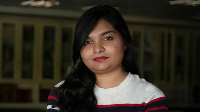 Zyma Islam, a reporter of the Daily Star newspaper, sitting in the office library in Dhaka and talking to BBC