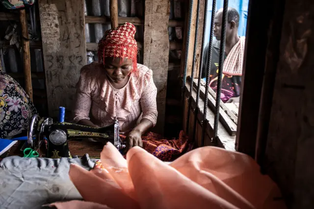 A tailor makes a dress in Freetown on April 12, 2022