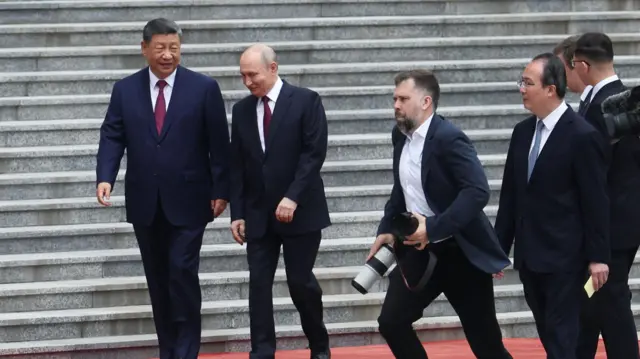 Russian President Vladimir Putin is welcomed by Chinese President Xi Jinping during a welcoming ceremony at the Great Hall of the People in Beijing, China May 20, 2026