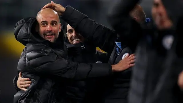 Guardiola celebrates with his coaching staff at Man City