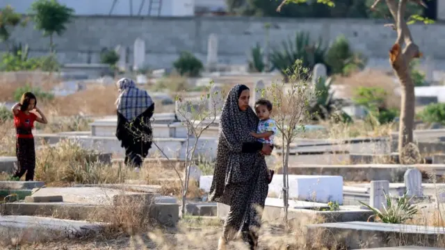 Palestinians visit di graves of dia relatives in di main cemetery of Beit Lahia for northern Gaza Strip on May 13, 2021.