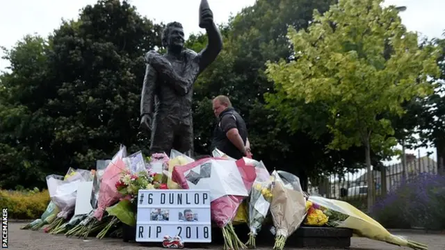 Tributes for William Dunlop, left at Robert's statue