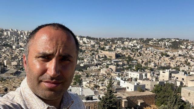 Issa Amro with buildings in the background