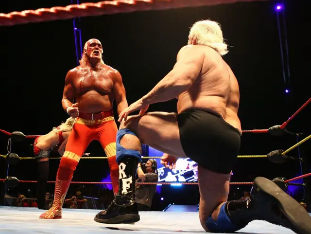 Hulk Hogan in the ring towering over Ric Flair, on one knee, during his Hulkamania Tour at the Burswood Dome on November 24, 2009 in Perth, Australia