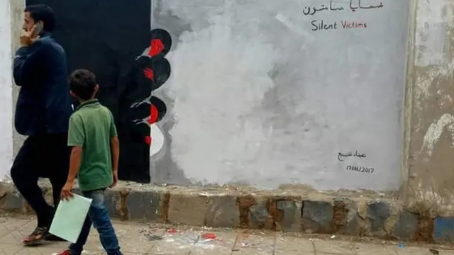 الجدارية تشرح الدمار الذي حدث ولازال يحدث في اليمن وتصور الجدارية امرأة وطفل بتابعون ما خلفته الحرب