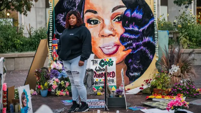 Tamika Palmer, the mother of Breonna Taylor, stands in front of a mural of her daughter in Louisville, Kentucky