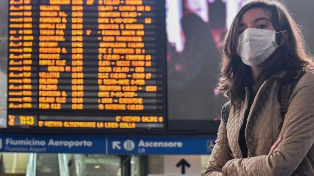 Woman with mask at Rome's Termini train station