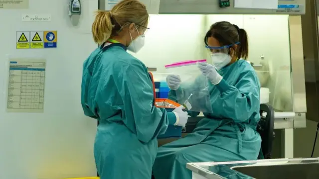 Two paramedics prepare to record data of a clinical trial of the Janssen Covid-19 vaccine