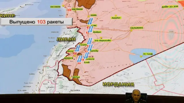 генерал-полковник на фоне карты Сирии