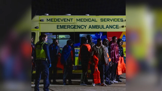 Asylum seekers arrive for medical check and searching biforboarding a coach to take dem to Dover for processing on the 22nd of November 2023 in Dungeness, United Kingdom