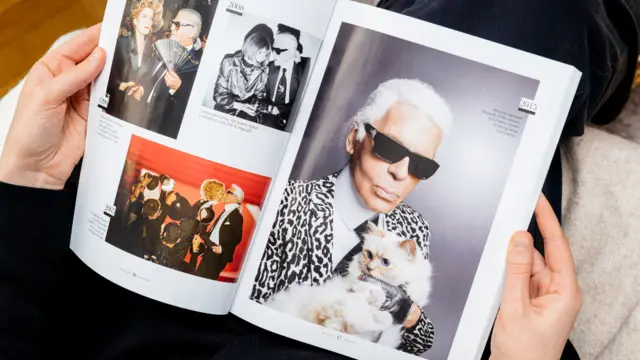 Paris, France - Feb 23, 2019: Woman dey read French magazine Le Figaro wey cover Karl Lagerfeld death, and im cat Choupette. Di ogbonge fashion designer die at di age of 85.