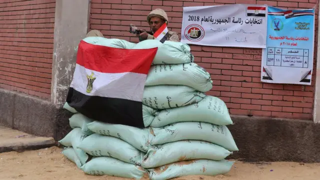 An Egyptian army soldier stands guard outside a polling station during the last day of the presidential election in Cairo, Egypt 28 March 2018.