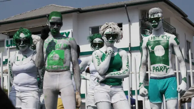 Liberty Party supporters dressed and painted in white and green attend a rally in Monrovia, Liberia - Tuesday 31 January 2017