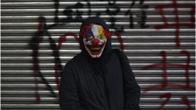 A protester wearing a scary clown mask poses during a rally in Tsuen Wan district in Hong Kong on October 1, 2019,