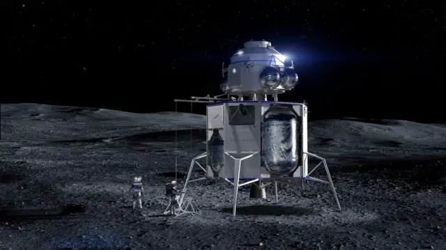 A tall, spindly spacecraft stands alone on a bleak grey plain under a black, star‑filled sky. This is Blue Origin’s Blue Moon lander: a white, boxy lower stage on four delicate legs, topped by a rounded cabin like a silver lighthouse. Bulging metallic tanks cling to its sides, catching harsh moonlight. A small ladder unfolds to the dust, where two astronauts in chunky white suits work beside scientific gear, their shadows stretching long across the cratered surface. The surrounding landscape is empty, rolling gently away into darkness, emphasising how exposed and futuristic this gleaming machine appears.