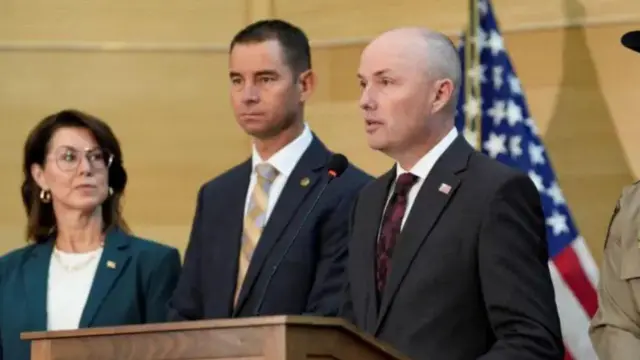 Utah govnor Spencer Cox and one man and one woman during one press conference