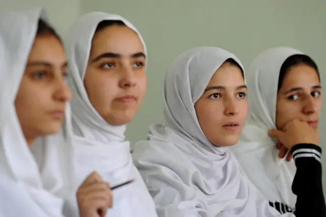 Afghan high school students listen during a class at the Lycee Malalai school in Kabul on September 26, 2011.