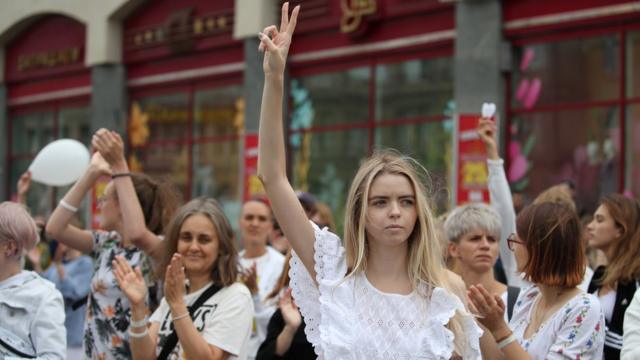 白俄罗斯（白罗斯）首都明斯克街头一名参与反对派示威的少女举起胜利手势（12/8/2020）