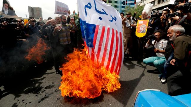 Protesters burn an American flag in Tehran