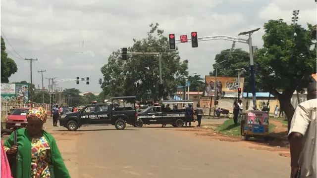 Police patrol vans block road to stop protesting workers from passing