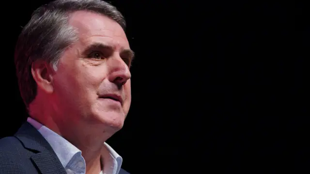 Perfil lateral del alcalde metropolitano, Steve Rotheram, con cabello gris, vistiendo una camisa azul pálido y una chaqueta azul marino.  
