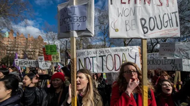 Women's rights demonstrators hold placards and chant during a rally in Russell Square on International Women's Day on March 8, 2018 in London, England. International Women's Day is annually held on March 8 to celebrate women's achievements throughout history and across nations. It is also known as the United Nations (UN) Day for Women's Rights and International Peace