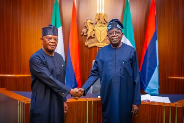  Vice Admiral Ibok-Ete Ibas (Rtd) and President Bola Tinubu shake hands