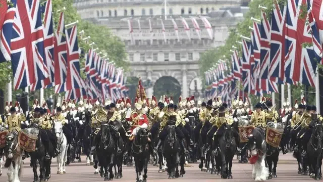 Guardsmen arrive back at Buckingham Palace from Horse Guards Parade after the annual Trooping the Colour ceremony in central London