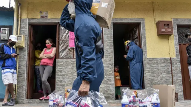 Residents receive humanitarian aid at their homes in the neighbourhood of Ciudad Bolivar on July 13, 2020 in Bogota, Colombia.