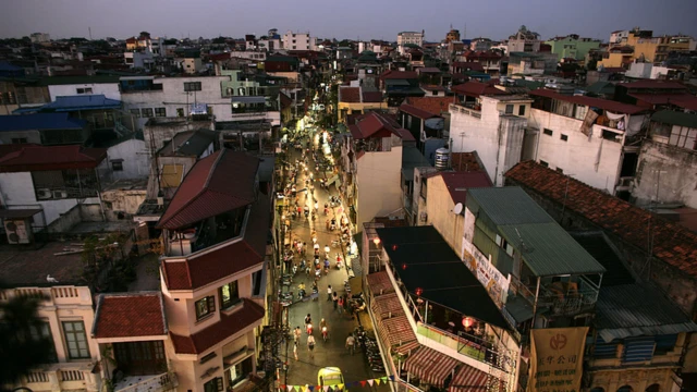 A busy street which motorcyclists and pedestrians in Hanoi, Vietnam.