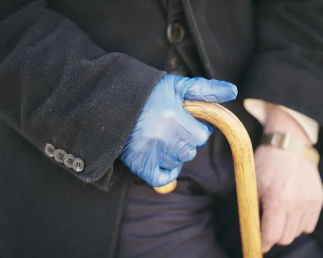 Hand holding walking stick