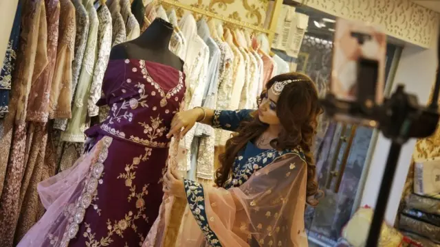 লাইভ স্ট্রিমিং-এর মাধ্যমে মডেল পোশাক প্রদর্শন করছেন।