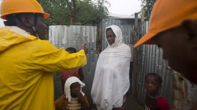 Civil protection workers ask residents to evacuate their homes in Haiti
