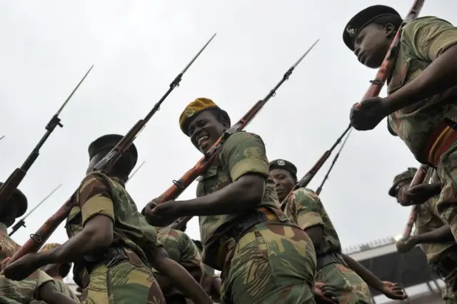 A soldier of the Zimbabwe Defence Force pulls a funny face as she marches in formation during drills to prepare for the inauguration of incoming president Emerson Mnangagwa at the capital Harare's national stadium Zimbabwe's former vice president Emmerson Mnangagwa flew home on November 22 to take power after the resignation of Robert Mugabe put an end to 37 years of authoritarian rule. Mnangagwa will be sworn in as president at an inauguration ceremony on November 24.