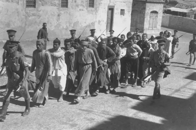 فلسطينيون مقيدون لنقلهم إلى سجن في القدس خلال فترة حظر التجول من قبل قوات الانتداب البريطانية، في 26 أكتوبر/تشرين الأول 1938