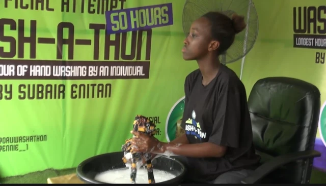 Lady dey wash clothes for black basin